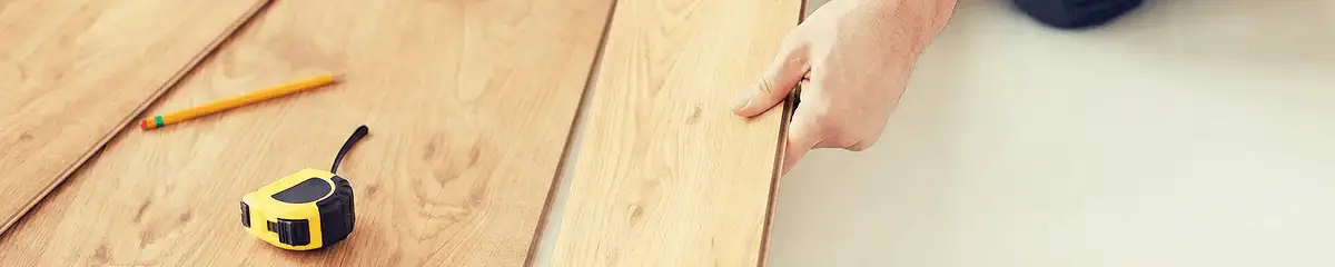 A professional installing wood flooring in Columbia, MO