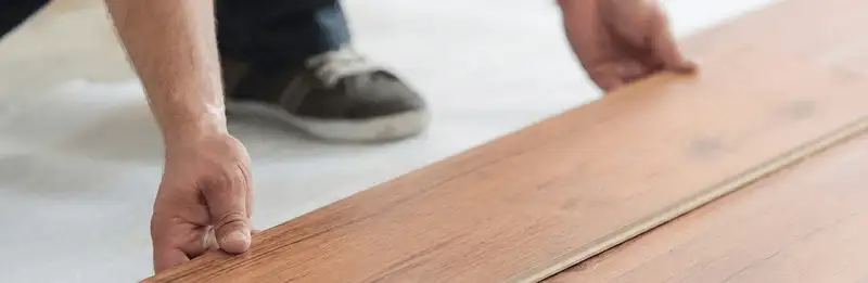 A professional installing laminate flooring in Columbia, MO